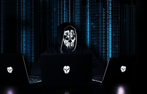 Computer hacker wearing a mask in Th3 C0d3 Escape Room Denver CO