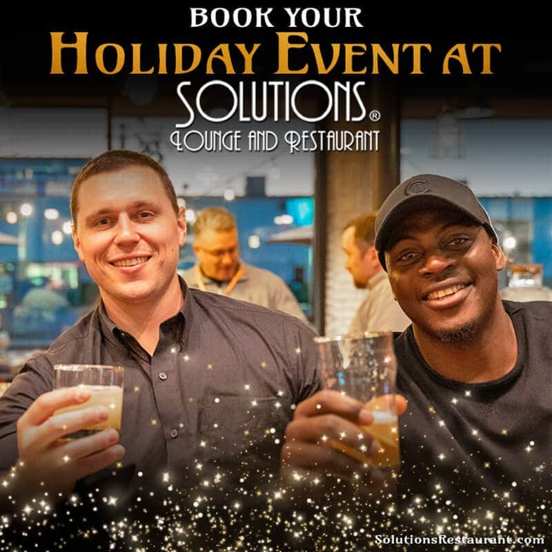 Two men toasting at the Solutions Lounge bar